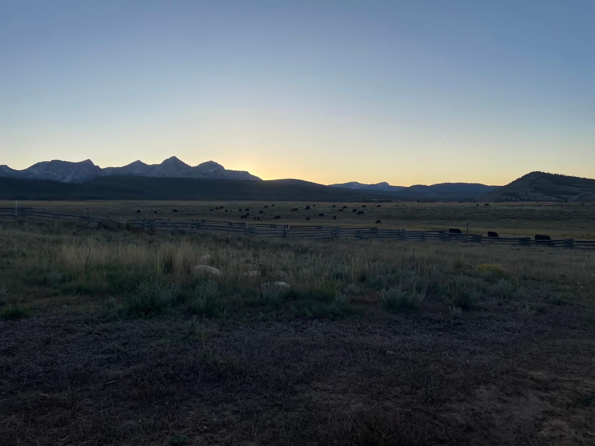 Sunset valley with the Sawtooth Mountains behind open ranchland near Ketchum, Idaho